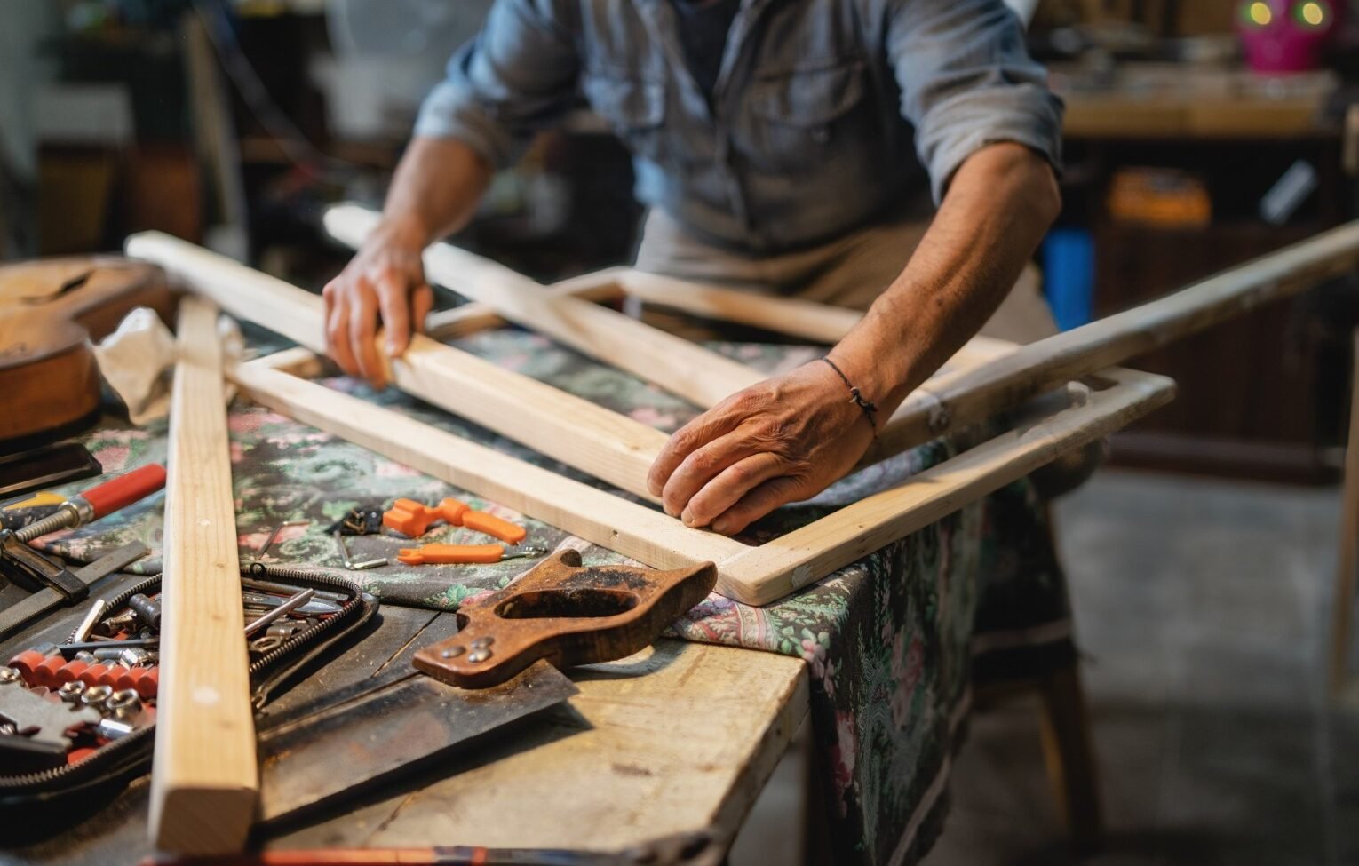 a carpenter builds a wooden frame on the workbench 78d6b8g