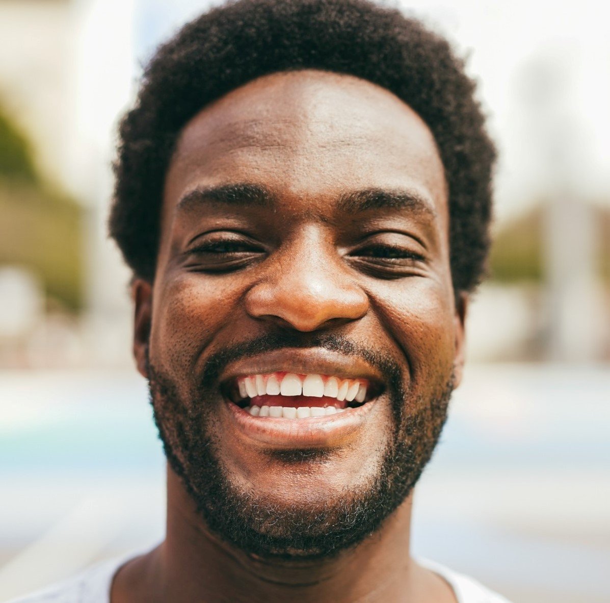 happy african man smiling at camera inside ba.jpg